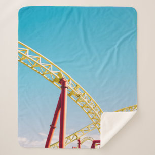 Yellow and red roller coaster under blue sky at da sherpa blanket