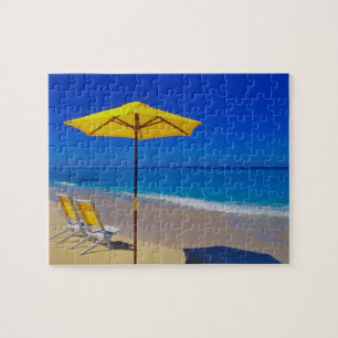 Yellow beach umbrella and chairs on pristine jigsaw puzzle