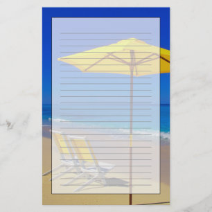 Yellow beach umbrella and chairs on pristine stationery