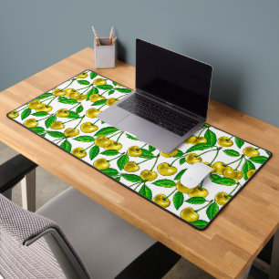Yellow cherries on white desk mat