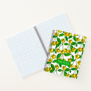 Yellow cherries on white notebook