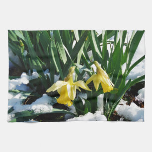 Yellow Daffodils flowers in the snow Tea Towel