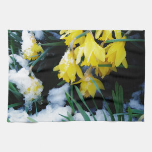 Yellow Daffodils flowers in the snow Tea Towel