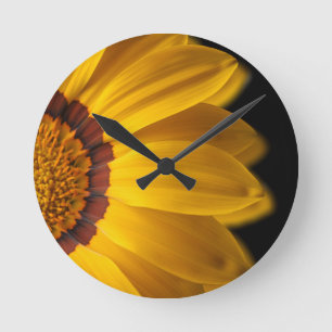 Yellow flower on  black background round clock