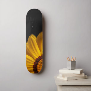 Yellow flower on black background skateboard
