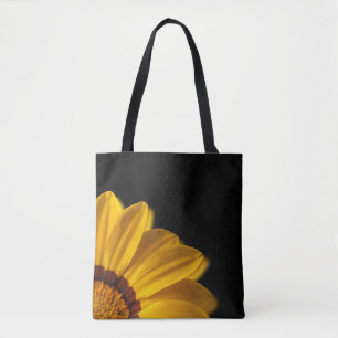Yellow flower on  black background tote bag