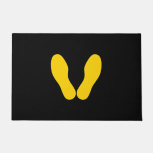 YELLOW FOOTPRINTS ON BLACK DOORMAT