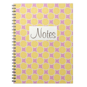 Yellow lemon slices on bright pink spiral notebook