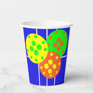 Yellow, orange, & green pickleballs on blue court paper cups