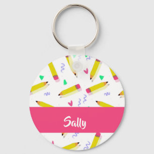 Yellow pencils and scrabbles on white key ring