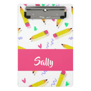 Yellow pencils and scrabbles on white mini clipboard