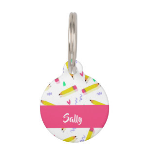 Yellow pencils and scrabbles on white pet tag