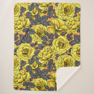 Yellow roses with grey leaves on orange sherpa blanket