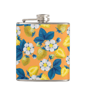 Yellow strawberries on orange hip flask