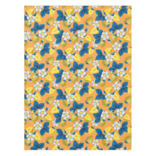 Yellow strawberries on orange tablecloth