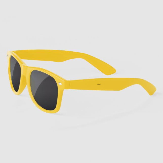 Yellow sunglasses with black lenses are viewed  (Left)