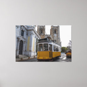 Yellow tram on Lisbon Cathedral in Portugal Canvas Print