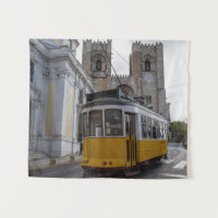 Yellow tram on Lisbon Cathedral in Portugal