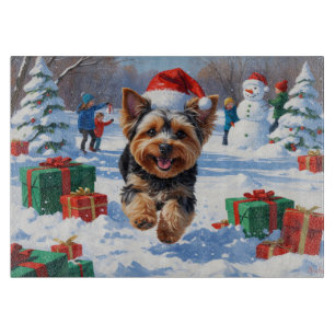 Yorkipoo Running in Snow with Christmas Hat Cutting Board