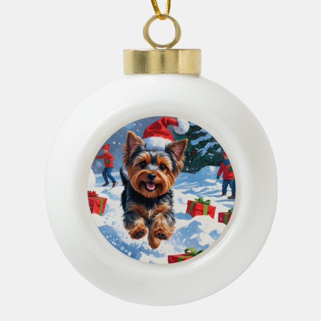 Yorkshire Terrier in Snow with Christmas Hat Ceramic Ball Christmas Ornament (Front)