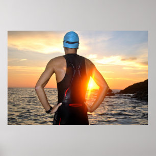 Young athlete triathlon in front of to sunrise poster