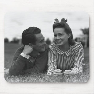 Young couple lying on grass mouse pad