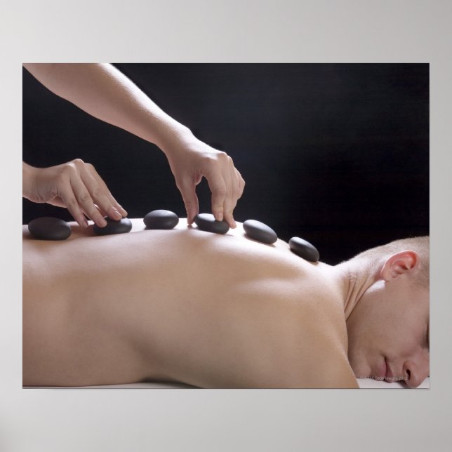 young man getting hot stone massage treatment poster (Front)