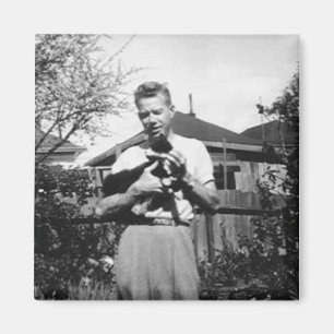 Young man holding a cat magnet