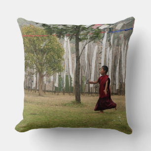 Young monk and prayer flags cushion