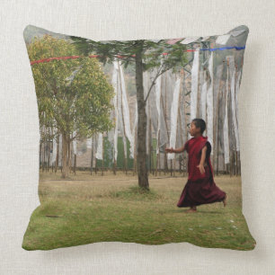 Young monk and prayer flags cushion