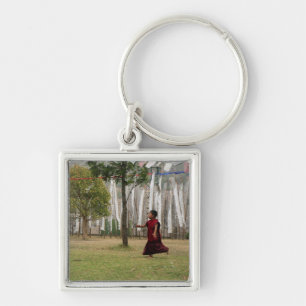 Young monk and prayer flags key ring