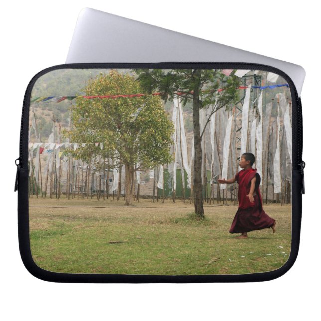 Young monk and prayer flags laptop sleeve (Front)