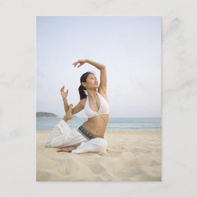 Young woman doing yoga on the beach postcard (Front)