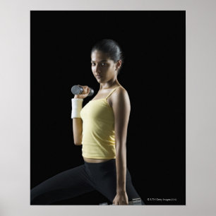 Young woman exercising with dumbbells poster