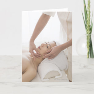 Young woman having facial massage card