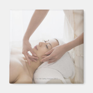 Young woman having facial massage magnet