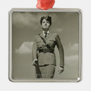 Young woman in military marching on rooftop metal tree decoration