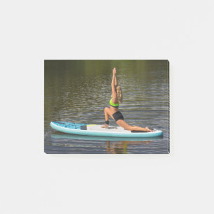 Young woman in warrior 1 pose on SUP Post-it Notes