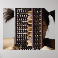 Young woman peering through abacus.